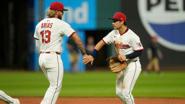 Cleveland Guardians shortstop Gabriel Arias (13) and left fielder Steven Kwan, right, celebrate after the Guardians defeated the Tampa Bay Rays in a baseball game in Cleveland, Tuesday, Aug. 26, 2025. (Sue Ogrocki/AP)
