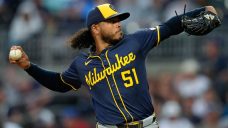 Peralta earns MLB-best 15th win as Brewers blank Cubs