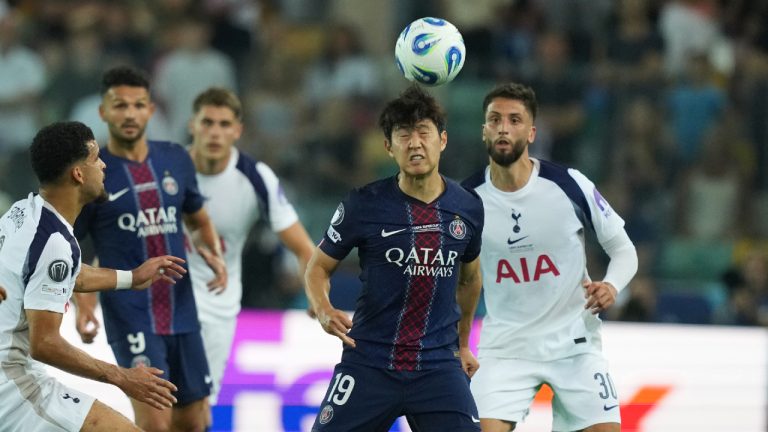 PSG's Kang-in Lee, centre, heads the ball during the UEFA Super Cup soccer match between Paris Saint-Germain and Tottenham Hotspur in Udine, Italy, Wednesday, Aug. 13, 2025. (Antonio Calanni/AP)