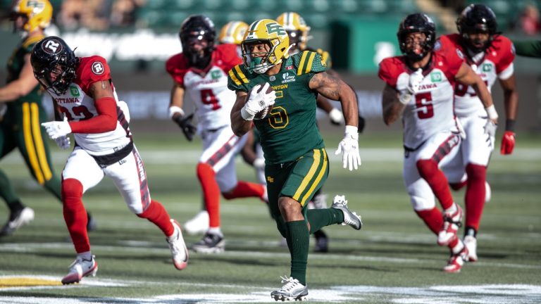Ottawa Redblacks players chase Edmonton Elks' Justin Rankin (5) during second half CFL action in Edmonton, on Sunday July 6, 2025. (Jason Franson/CP)