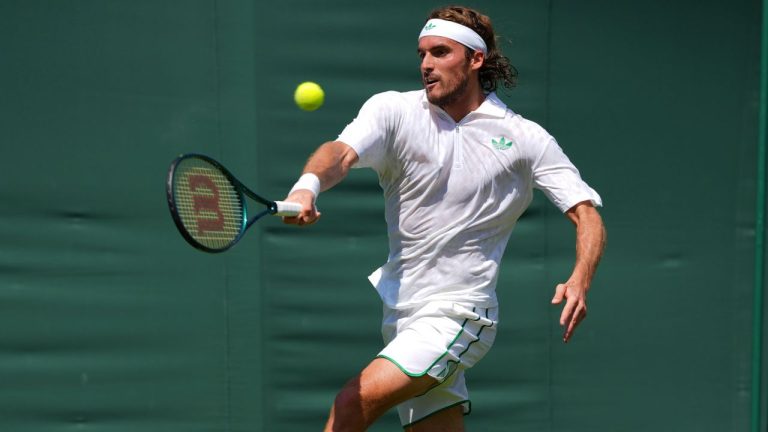 Stefanos Tsitsipas of Greece returns the ball to Valentine Royer of France during their first round men's single match at the Wimbledon Tennis Championships in London, Monday, June 30, 2025. (Kirsty Wigglesworth/AP)