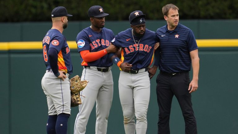 Houston Astros center fielder Taylor Trammell, second from right, is helped after being injured attempting to catch a Detroit Tigers' Dillon Dingler fly ball in the first inning during a baseball game Wednesday, Aug. 20, 2025, in Detroit. (Paul Sancya/AP)