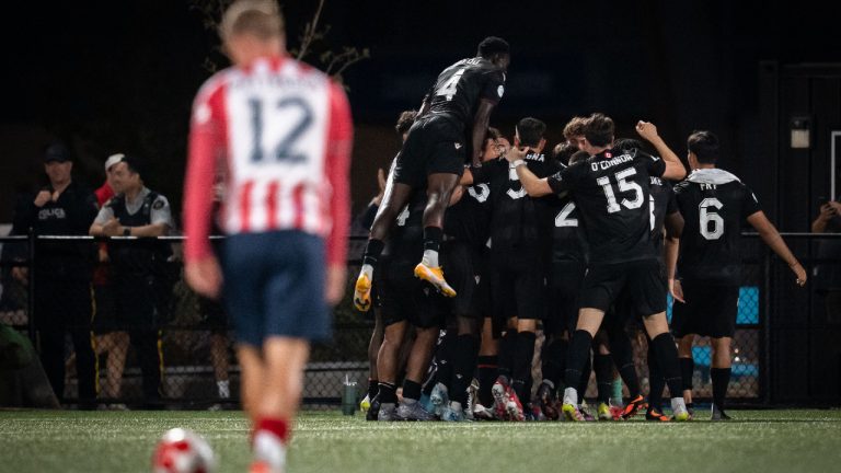 Vancouver FC celebrates Nicolas Mezquida's goal against Ottawa Atletico as Ottawa Atletico's Monty Patterson (12) watches during second half Canadian Championship semifinal soccer action, in Langley, B.C., on Wednesday, August 13, 2025. (Ethan Cairns/CP)