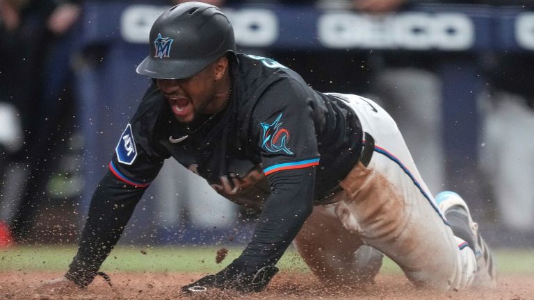Miami Marlins' Xavier Edwards scores the winning run in the ninth inning of a baseball game against the New York Yankees, Friday, Aug. 1, 2025, in Miami. (Rebecca Blackwell/AP)