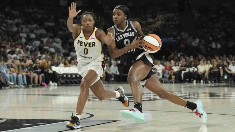 Las Vegas Aces guard Jackie Young, right, drives past Indiana Fever guard Kelsey Mitchell, left, in the first half of Game 1 of a WNBA basketball playoff semifinals series Sunday, Sept. 21, 2025, in Las Vegas. (Candice Ward/AP)