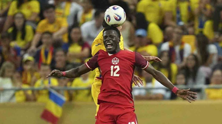 Canada's Tani Oluwaseyi jumps for a header during an international friendly soccer match between Romania and Canada at the National Arena stadium in Bucharest, Romania, Friday, Sept. 5, 2025. (Andreea Alexandru/AP)