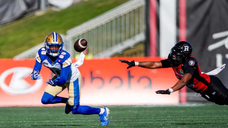 Winnipeg Blue Bombers wide receiver Ontaria Wilson (80) attempts a catch as Ottawa Redblacks defensive back Adrian Frye (22) attempts a block during first half CFL action in Ottawa, on Saturday, Sept. 20, 2025. (Spencer Colby/CP)