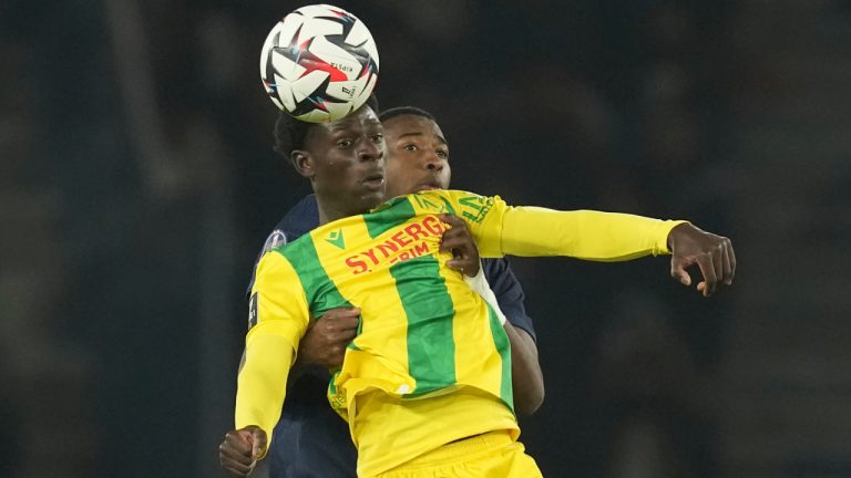 Nantes' Herba Guirassy, front, and PSG's Willian Pacho challenge for the ball during the French League One soccer match between Paris Saint-Germain and Nantes at the Parc des Princes stadium in Paris, France, Saturday, Nov. 30, 2024. (Christophe Ena/AP)