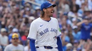 Toronto Blue Jays pitcher Kevin Gausman (34) reacts after picking off Milwaukee Brewers' Caleb Durbin at first base during third inning MLB baseball action in Toronto on Saturday, August 30, 2025. (Frank Gunn/CP)