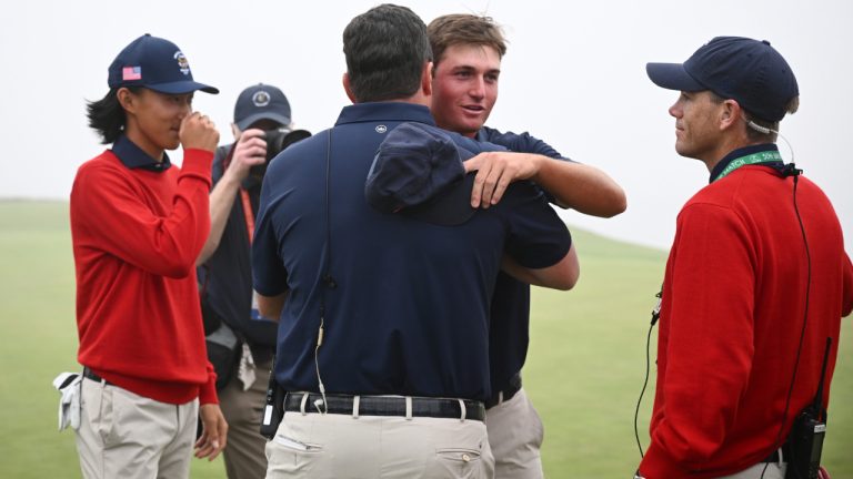 USA's Preston Stout is hugged by captain Nathan Smith after their win over Great Britain and Ireland during the Walker Cup golf tournament at Cypress Point Club on Sunday, Sept. 7, 2025, in Pebble Beach, Calif. (Thien-An Truong/AP)