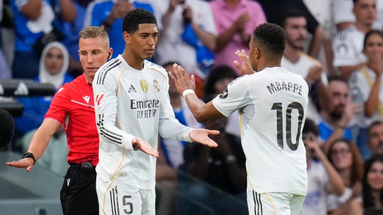 Real Madrid's Kylian Mbappe, right, leaves the pitch during a substitution for Jude Bellingham, centre, during the La Liga match between Real Madrid and Espanyol in Madrid, Spain, Saturday, Sept. 20, 2025. (Manu Fernandez/AP)
