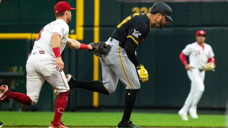 Cincinnati Reds second base Matt McLain tags out Pittsburgh Pirates' Tommy Pham while attempting to steal second base in the second inning of a baseball game, Wednesday, Sept. 24, 2025, in Cincinnati. (AP Photo/Michael Swensen)
