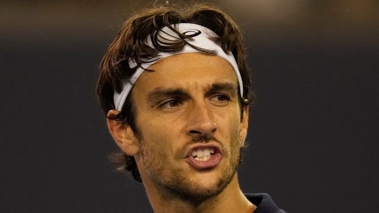 Lorenzo Musetti of Italy reacts during play against Giovanni Mpetshi Perricard of France in a men's singles match for the China Open tennis tournament in Beijing, China, Friday, Sept. 26, 2025. (AP Photo/Ng Han Guan)