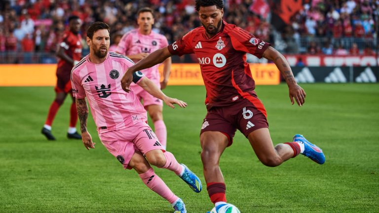 Inter Miami's Lionel Messi battles for the ball with Toronto FC's Kosi Thompson during MLS action in Toronto, on Saturday, Sept. 27, 2025. (Sammy Kogan/CP)