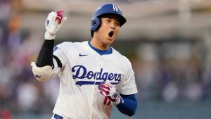 Los Angeles Dodgers' Shohei Ohtani celebrates as he rounds the bases after his solo home run during the first inning in Game 1 of the National League Wild Card baseball playoff series against the Cincinnati Reds, Tuesday, Sept. 30, 2025, in Los Angeles. (Mark J. Terrill/AP)