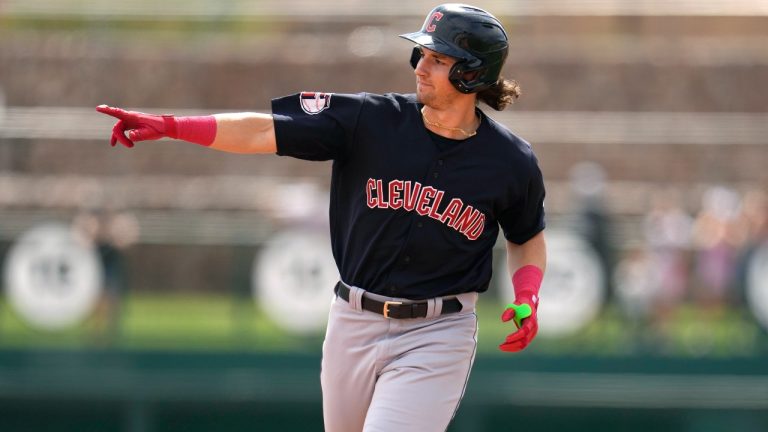 Cleveland Guardians' Chase DeLauter points as he rounds the bases after hitting a three-run home run against the Chicago White Sox during the first inning of a spring training baseball game Monday, March 18, 2024, in Phoenix. (AP Photo/Ross D. Franklin)