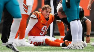Cincinnati Bengals quarterback Joe Burrow (9) grimaces aft being sacked by Jacksonville Jaguars defensive tackle Arik Armstead (91) during the first half of an NFL football game, Sunday, Sept. 14, 2025, in Cincinnati. (Carolyn Kaster/AP)