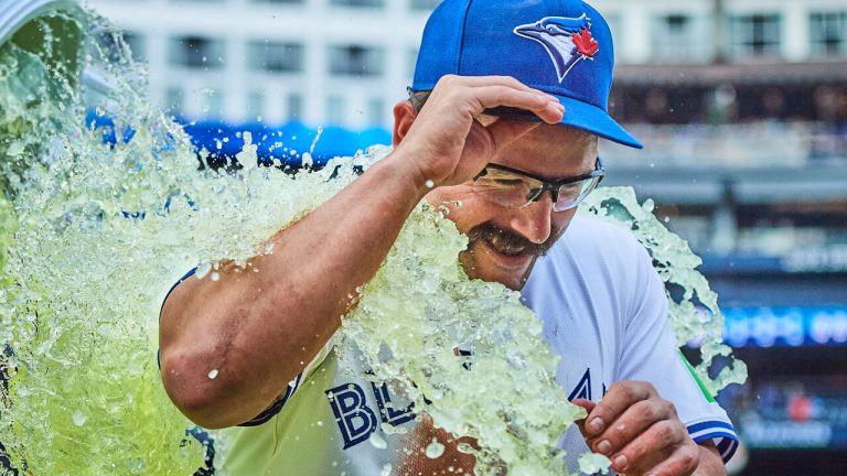 Toronto Blue Jays utilityman Davis Schneider (36) is doused in Gatorade by his teammates after winning against the Kansas City Royals at home in early August. (Photo by Sammy Kogan/CP)