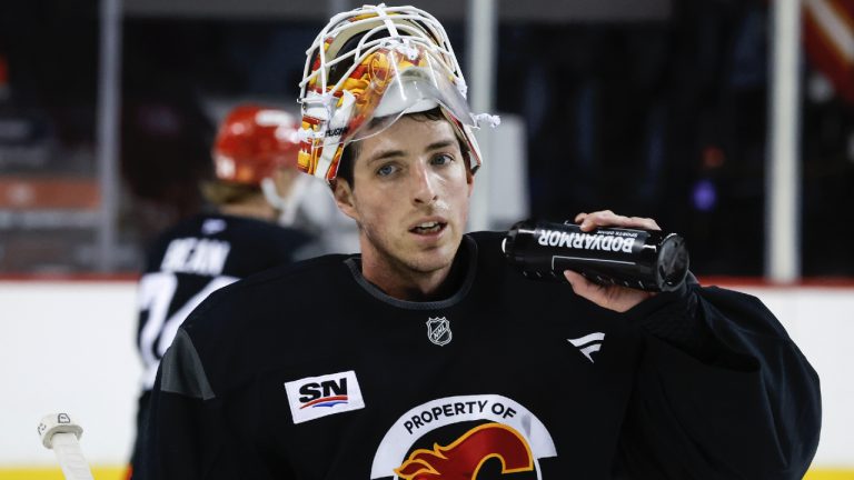 Calgary Flames goalie Devin Cooley takes a water break during a training camp practice in Calgary, Alta., Thursday, Sept. 18, 2025. (Jeff McIntosh/CP)
