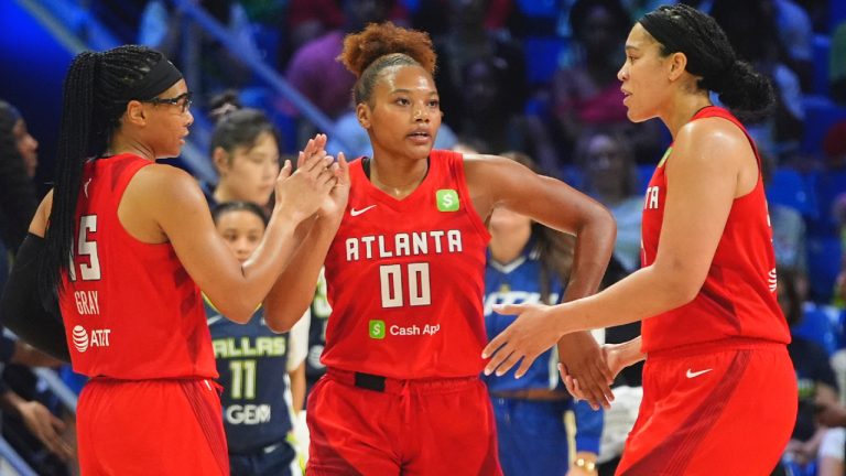 Atlanta Dream forward Naz Hillmon (00) celebrates with teammates guard Allisha Gray (15) and forward Brionna Jones (24) during the second half of a WNBA basketball game against the Dallas Wings in Arlington, Texas, Wednesday, July 30, 2025. (LM Otero/AP)