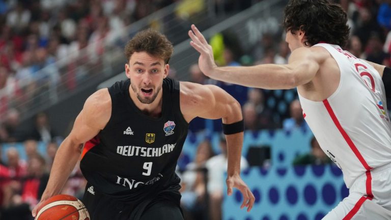 Germany's Franz Wagner, left, drives to the basket as Turkey's Cedi Osman tries to block him during the Eurobasket, European Basketball Championship final match between Turkey and Germany at the Riga Arena in Riga, Latvia, Sunday, Sept. 14, 2025. (Sergei Grits/AP)