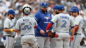 Toronto Blue Jays manager John Schneider, centre, stands on the mound after pulling Max Scherzer during the fifth inning of a game against the New York Yankees, Sunday, Sept. 7, 2025, in New York. (Heather Khalifa/AP)