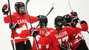 Marie-Philip Poulin of Canada, right, celebrates with teammates after scoring her sides second goal during the semi final match between Canada and Finland at the Women's Ice Hockey Championships in Ceske Budejovice, Czech Republic, Saturday, April 19, 2025. (Petr David Josek/AP)