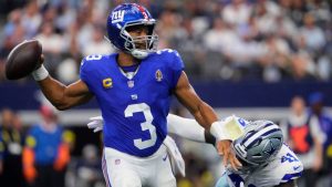 New York Giants quarterback Russell Wilson (3) throws a pass under pressure from Dallas Cowboys defensive end Donovan Ezeiruaku (41) in the second half of an NFL football game Sunday, Sept. 14, 2025, in Arlington, Texas. (Jeffrey McWhorter/AP)