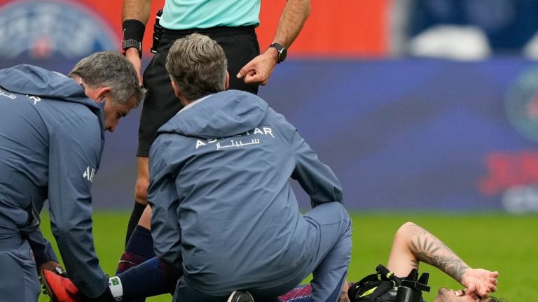 Medics taking care of PSG's Lucas Beraldo who was injured during the French League One soccer match between Paris Saint-Germain and Lens at the Parc des Princes stadium in Paris, Sept. 14, 2025. (Michel Euler/AP)