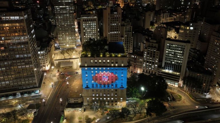 An image of a football is projected onto the city hall building in downtown São Paulo to promote the NFL season opener between the Los Angeles Chargers and the Kansas City Chiefs, Sept. 3, 2025. (Andre Penner/ AP)