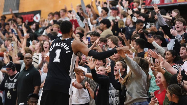 San Antonio Spurs centre Victor Wembanyama (1) interacts with students as he and teammates make a surprise visit to Tom Moore High School in Ingram, Texas, to visit the students and families of those impacted by flooding that killed more than 130 people across the region, Wednesday, Sept. 10, 2025. (Eric Gay/AP)
