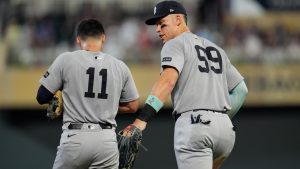 New York Yankees outfielder Aaron Judge speaks with Anthony Volpe in the fifth inning of a baseball game against the Minnesota Twins, Tuesday, Sept. 16, 2025, in Minneapolis. (Mike Stewart/AP)