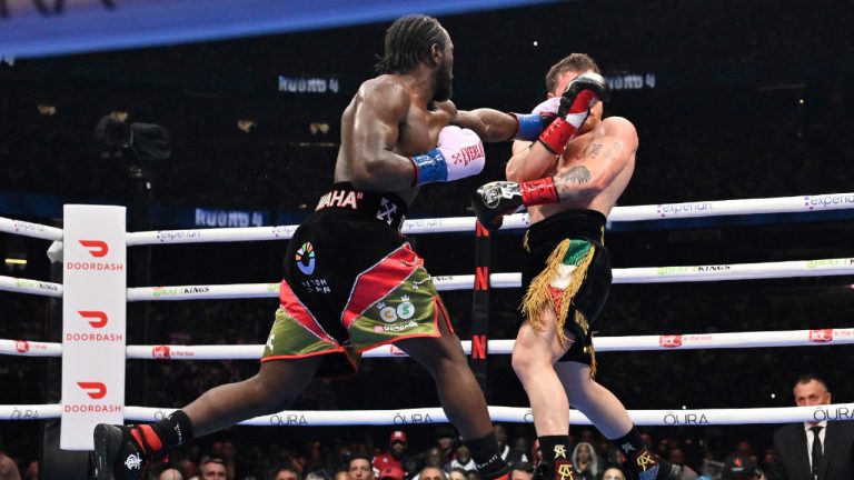 Terence Crawford, left, punches Canelo Alvarez during an undisputed super middleweight championship boxing match in Las Vegas, Saturday, Sept. 13, 2025. (David Becker/AP)
