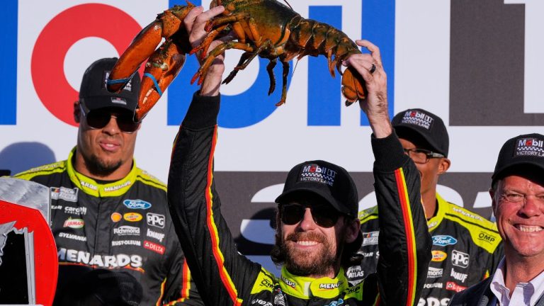 Ryan Blaney hoists a lobster in Victory Lane after winning a NASCAR Cup Series race at New Hampshire Motor Speedway, Sunday, Sept. 21, 2025, in Loudon, N.H. (Charles Krupa/AP Photo)