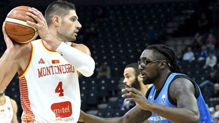Britain's Jubrile Belo, right, and Montenegro's Nikola Vucevic, left, challenge for the ball during the Eurobasket, European Basketball Championship, group B match between Montenegro and Great Britain in Tampere, Finland. (Heikki Saukkomaa/AP)