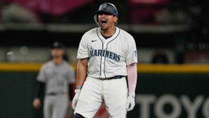 Seattle Mariners' Josh Naylor reacts after hitting a three-run double that scored Luke Raley, J.P. Crawford, and Julio Rodriguez during the eighth inning of a baseball game against the Colorado Rockies, Tuesday, Sept. 23, 2025, in Seattle. (Ryan Sun/AP)