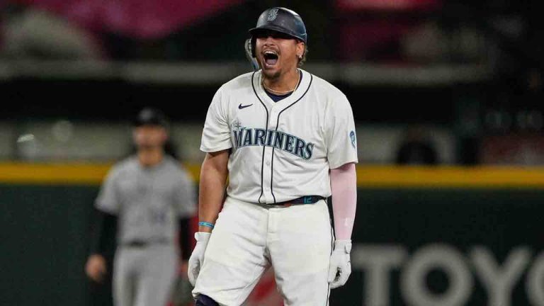 Seattle Mariners' Josh Naylor reacts after hitting a three-run double that scored Luke Raley, J.P. Crawford, and Julio Rodriguez during the eighth inning of a baseball game against the Colorado Rockies, Tuesday, Sept. 23, 2025, in Seattle. (Ryan Sun/AP)