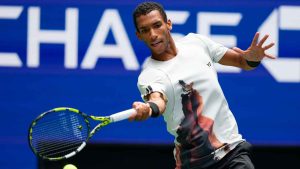 Felix Auger-Aliassime, of Canada, returns a shot to Alex de Minaur, of Australia, during the quarterfinal round of the U.S. Open tennis championships. (Yuki Iwamura/AP)
