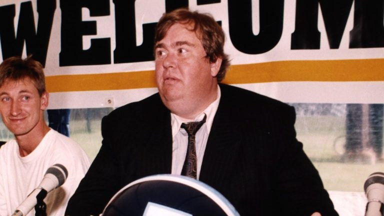 Toronto's Argonauts' co-owners John Candy (right) and Wayne Gretzky along with player Raghib (Rocket) Ismail (left) talk to reporters at the team's training camp in Guelph, Ont. June 7, 1991. At extreme right is Gretzky's daughter Paulina. (Hans Deryk/CP)