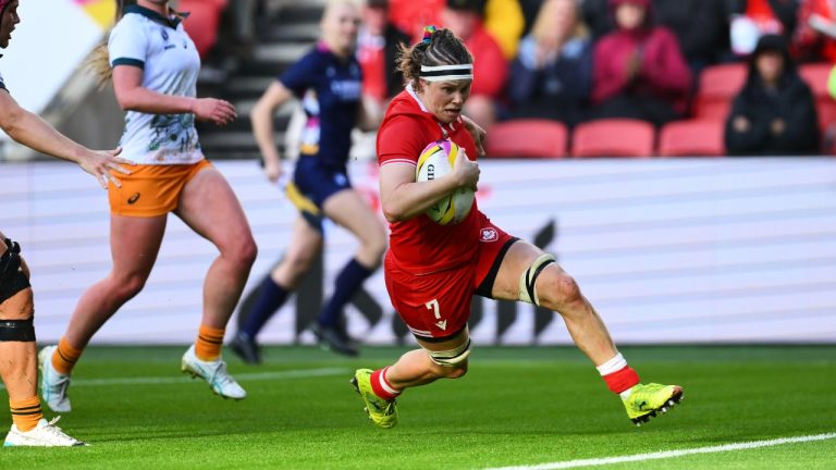 Canada's Karen Paquin, right, scores a try during the Women's Rugby World Cup 2025 quarterfinal match between Canada and Australia, in Bristol, England, Saturday, Sept. 13, 2025. (Anthony Upton/AP)