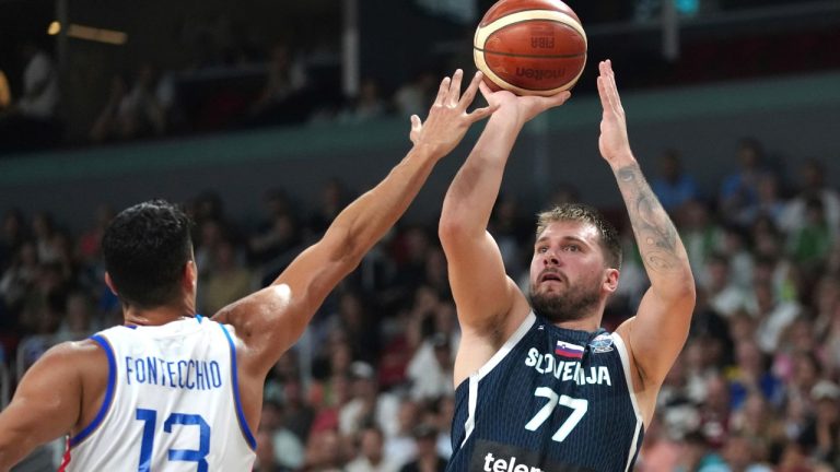 Slovenia's Luka Doncic tries to shoot while defended by Italy's Simone Fontecchio during the Eurobasket, European Basketball Championship round of 16 match between Italy and Slovenia at the Riga Arena in Riga, Latvia, Sunday, Sept. 7, 2025. (Sergei Grits/AP)