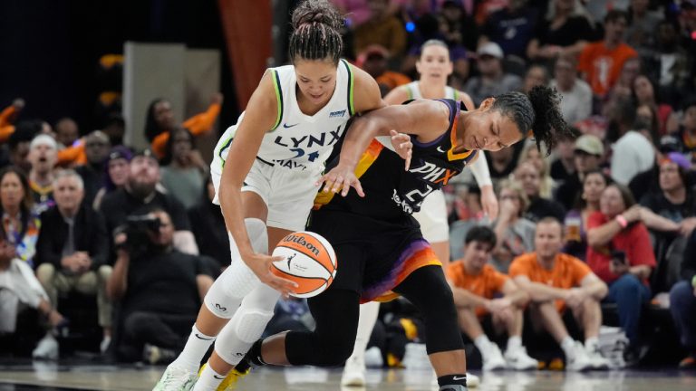 Minnesota Lynx forward Napheesa Collier, left, steals the ball from Phoenix Mercury forward Alyssa Thomas during the first half of Game 3 of a WNBA basketball playoff semifinals series game Friday, Sept. 26, 2025, in Phoenix. (Ross D. Franklin/AP)