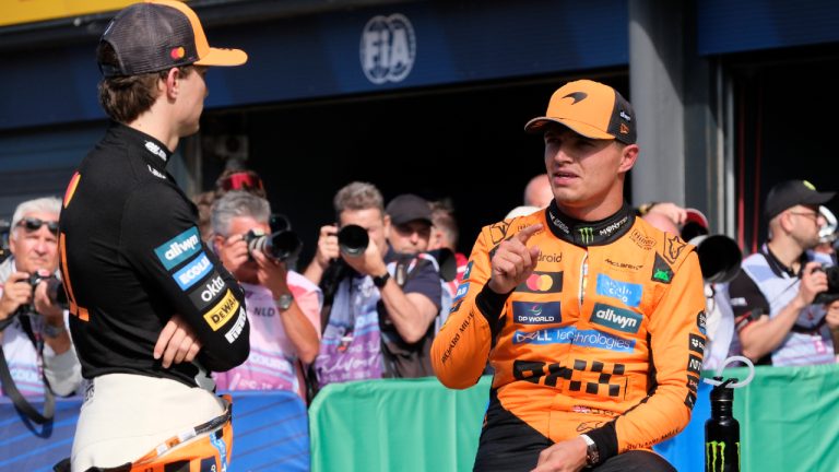 McLaren driver Lando Norris of Britain, right, talks to McLaren driver Oscar Piastri of Australia after the qualifying session ahead of the Formula One Dutch Grand Prix at the Zandvoort racetrack in Zandvoort, Netherlands, Saturday, Aug. 30, 2025. (Patrick Post/AP)