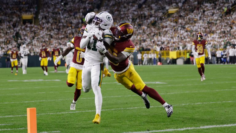 Green Bay Packers wide receiver Jayden Reed (11) makes a catch as Washington Commanders cornerback Mike Sainristil (0) and safety Quan Martin, right, defend before the play was nullified because of a Packers penalty during the first half of an NFL football game Thursday, Sept. 11, 2025, in Green Bay, Wis. (Matt Ludtke/AP)