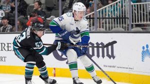 Vancouver Canucks defenceman Elias Pettersson (25) battles for the puck against San Jose Sharks center Ty Dellandrea (53) during the first period of an NHL hockey game in San Jose, Calif., Thursday, Feb. 6, 2025. (Tony Avelar/AP Photo)
