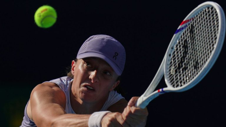 Iga Swiatek, of Poland plays a backhand return to Camila Osorio, of Colombia during the women's singles match for the China Open tennis tournament, in Beijing, Monday, Sept. 29, 2025. (Andy Wong/AP Photo)