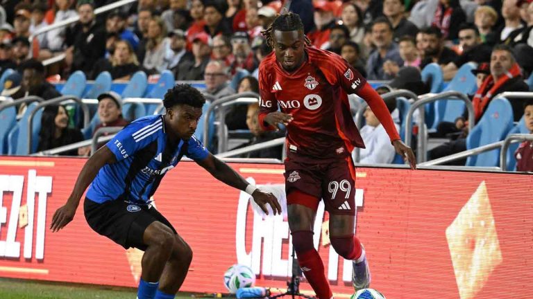 Toronto FC's Jules-Anthony Vilsaint, right, gets the ball ahead of CF Montreal's Dante Sealy during second half MLS soccer action. (Jon Blacker/CP)