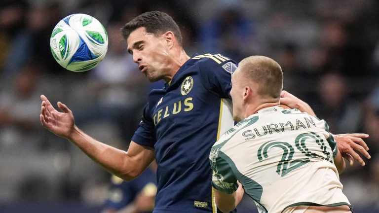 Vancouver Whitecaps' Daniel Rios, back left, and Portland Timbers' Finn Surman vie for the ball during the second half of an MLS soccer match, in Vancouver, on Wednesday, September 24, 2025. (Darryl Dyck/THE CANADIAN PRESS)