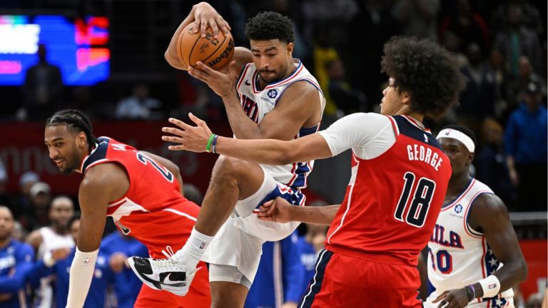 Philadelphia 76ers guard Quentin Grimes, centre, intercepts an inbound pass between Washington Wizards centre Alex Sarr and Wizards forward Kyshawn George (18) in the final seconds of overtime during an NBA basketball game, Tuesday, Oct. 28, 2025, in Washington. (John McDonnell/AP Photo)