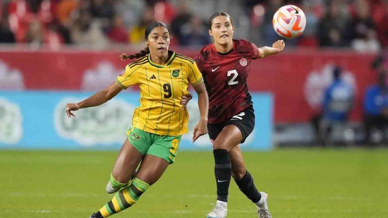 Canada's Sydney Collins, 2, battles Jamaica's Kameron Simmonds for the ball during first half CONCACAF women's championship soccer series match in Toronto on Tuesday Sept. 26, 2023. Defender Collins will not compete for the Canadian women's soccer team at the Paris Olympics after fracturing her left leg during a closed-door match against Nigeria on Wednesday. (Nathan Denette/CP)